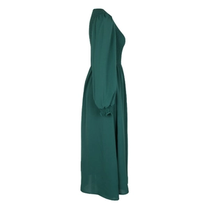 Detail of smocked bodice and lantern sleeves on a forest green A-line dress