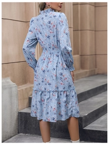 Detailed back view of a light blue floral chiffon dress with elastic waist and ruffle hem