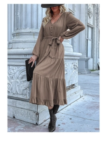Detail of V-neck long sleeve dress with button-down front and tiered skirt layering