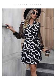 Detail of wrap dress with black and white letter print and sheer mesh polka dot sleeves