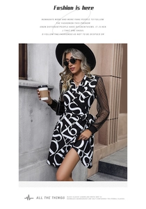 Detail of V-neck wrap dress featuring letter print and black polka dot mesh sleeves