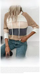 Close-up of hollow-out crochet texture and colorful stripes on women's hooded sweater