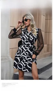 Detail of mesh sleeves with polka dots and black and white letter print wrap dress