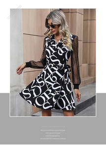Detail of wrap mini dress featuring letter print, waist tie and sheer mesh sleeves