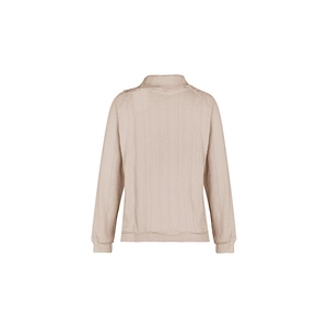 Close-up of textured knit fabric and button detail on high neck ribbed sweatshirt