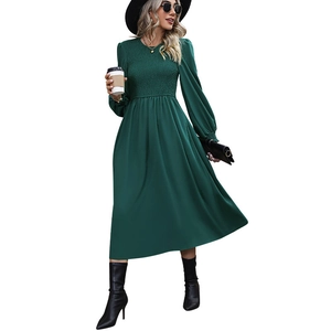 Elegant dark green smocked midi dress with long lantern sleeves and a refined A-line silhouette