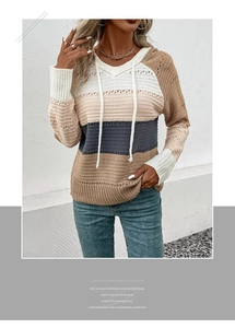 Detail of hollow-out knit texture and striped color blocks on a hooded sweater