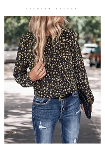 Detail of long sleeve leopard print shirt for women with a dark base and round neck design