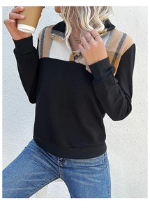 Detail of vintage patchwork sweatshirt featuring plaid collar and textured wavy fabric