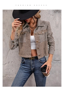 Detail of a vintage cropped plaid jacket for women with brown lapels and breast pockets
