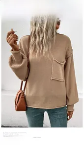 Detail shot of camel crewneck sweater featuring loose knit texture and front chest pocket