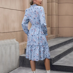 Elegant light blue long sleeve floral midi dress with high neck and smocked waist detail