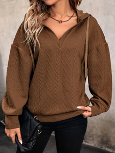 Close-up of coffee brown knit hoodie featuring unique diamond textured fabric and V-neckline