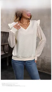 Detail of ruffled shoulders and quilted diamond pattern on beige lace patchwork top