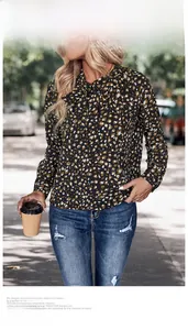 Detail of leopard print chiffon blouse featuring a vintage bow tie neckline in outdoor light