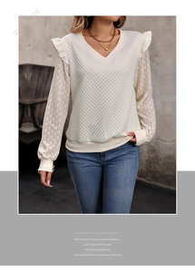 Close-up of quilted fabric texture and delicate lace sleeves on this v-neck sweatshirt