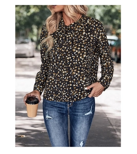 Detail of elegant pussy-bow necktie and floral print on long sleeve chiffon blouse