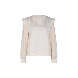 Detail of cream white V-neck sweatshirt featuring quilted texture and lace ruffle sleeves