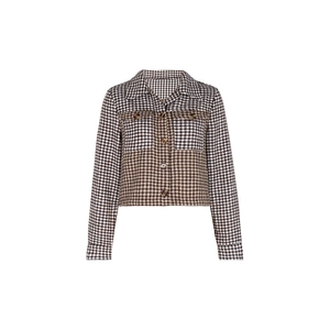 Detail of cropped plaid jacket showing spliced houndstooth patterns and polo collar
