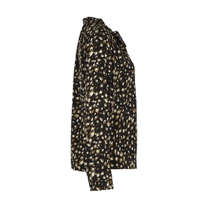 Close-up of leopard print blouse fabric with elegant bow-tie neck and sleeve detail