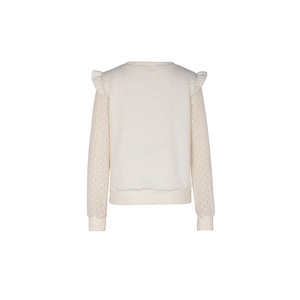 Detail of cream sweatshirt featuring quilted texture, ruffle trim, and lace sleeves
