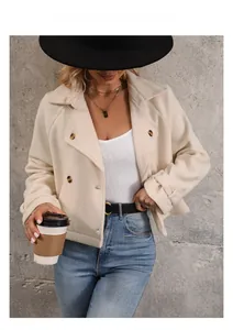 Detail of cream fleece jacket with double-breasted brown buttons and buttoned cuffs