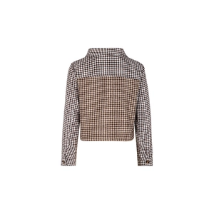 Back view of a cropped houndstooth jacket with contrast patchwork and buttoned cuffs