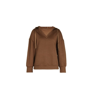 Close-up of brown textured knit hoodie featuring embossed patterns and V-neck drawstrings
