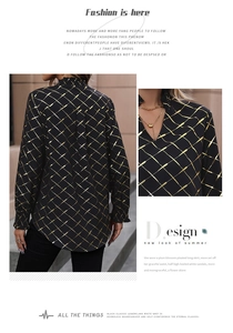 Detail of ruffled stand collar and gold geometric pattern on black long sleeve blouse