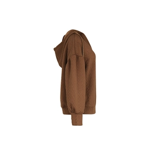 Detailed view of brown knit hoodie showing geometric embossed texture and ribbed cuffs