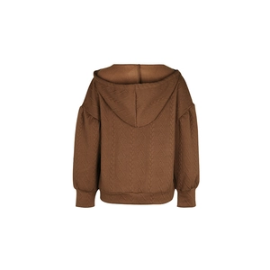 Close-up of brown oversized knit hoodie with textured cable knit patterns and lantern sleeves