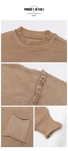 Detail view of brown knit sweater featuring rolled edges on the pocket and ribbed cuffs