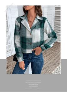 Close-up of green and white plaid pattern texture and button details on short coat