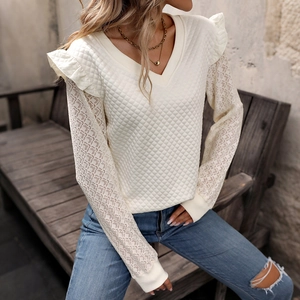 White quilted V-neck top with lace long sleeves and ruffle shoulder details on a model
