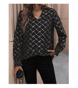 Detail of V-neck long sleeve blouse with gold geometric grid patterns on black fabric