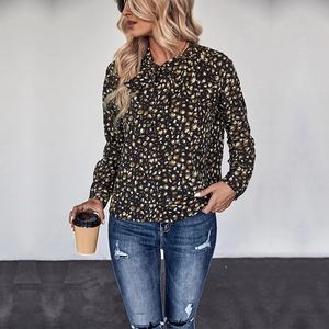 Women's leopard print long sleeve shirt with a bow tie collar and casual blue jeans