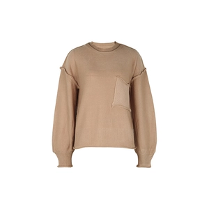 Detail of camel crewneck sweater featuring raw edge pocket and external seam stitching