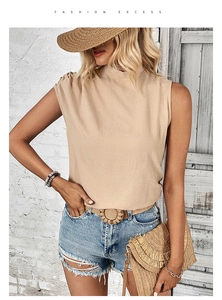 Detail of elegant beige sleeveless high-neck top featuring pleated shoulder accents