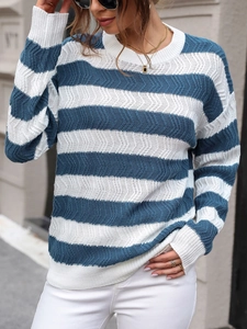 Detail shot of the wavy knit texture and ribbed cuffs on this blue striped sweater
