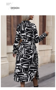 Detail of long-sleeve midi dress featuring bold black and white abstract geometric prints