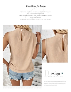 Detail view of beige sleeveless pleated top showing button closure and linen texture