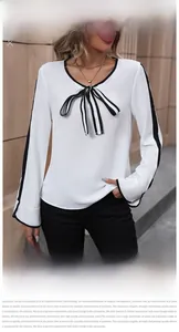 Detail of white chiffon blouse featuring a striped bow tie and contrast sleeve trim