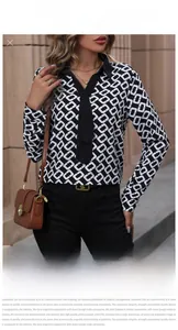 Detail of long sleeve shirt featuring black and white geometric prints and chic v-neckline
