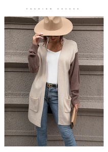 Detail of loose-fit beige knit cardigan with brown ribbed sleeves and side pockets