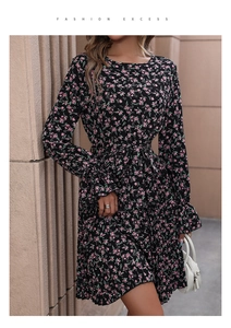 Detail of floral long sleeve dress with ruffle cuffs and pink floral pattern on black fabric