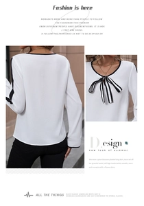 Detail view of white long-sleeved shirt with black contrast trim and striped bow-knot tie