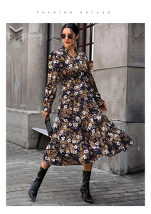Detail of floral V-neck dress featuring layered ruffle skirt and chiffon texture