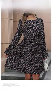 Detail view of long-sleeve floral dress with pleated skirt and waist drawstring tie