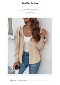 Detail of beige corduroy hooded jacket showing white buttons and drawstring texture