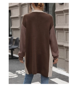 Detail view of the chunky knit texture and color-block design on back of long cardigan